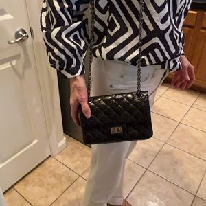 Chanel small black leather bag on dark grey metal  chain Quilted leather